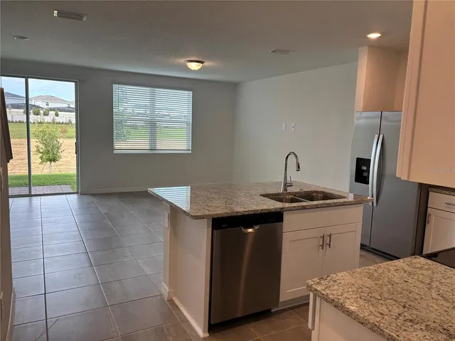 a kitchen with a sink a stove and a refrigerator