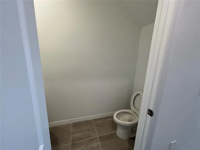 a white toilet sitting next to a shower