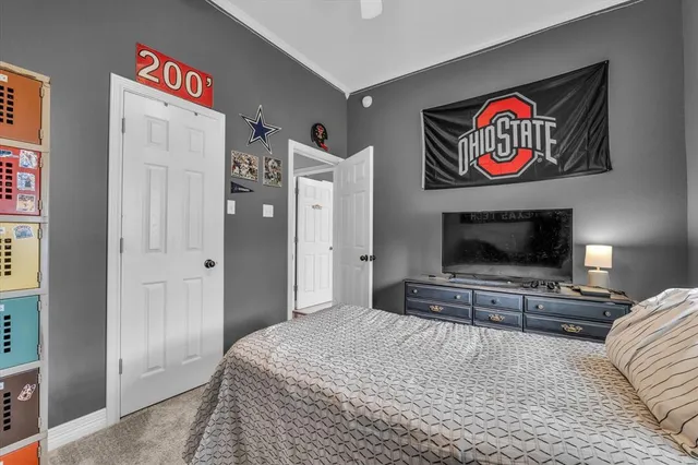 a bedroom with a bed and a television