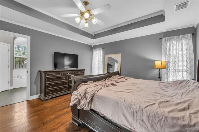 a bedroom with bed and a chandelier