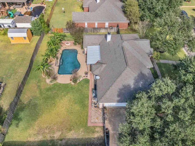 an aerial view of house with yard swimming pool and outdoor seating