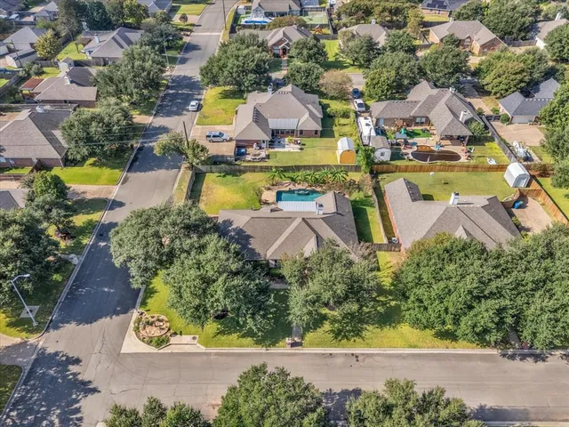 an aerial view of residential houses with outdoor space