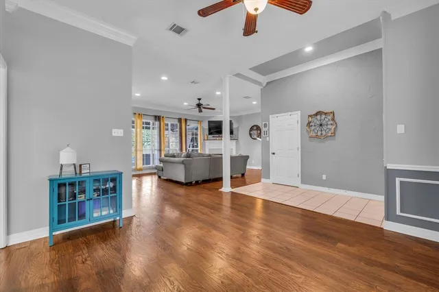 a view of a living room with furniture and wooden floor