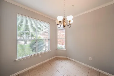 a view of a big room with windows and chandelier