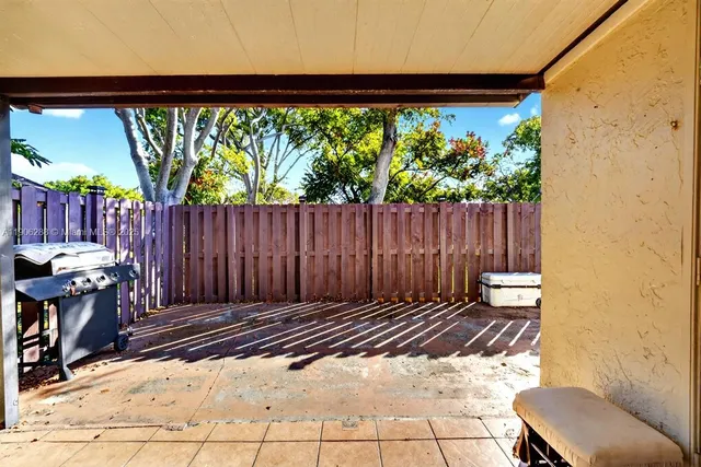 a view of a patio with table and chairs and potted plants