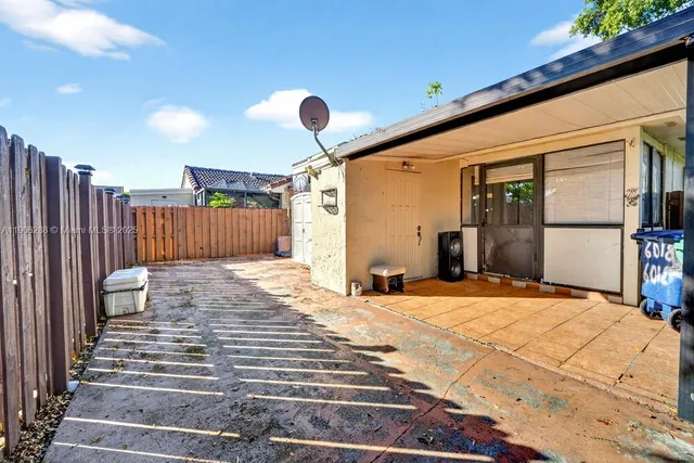 a view of backyard with potted plants