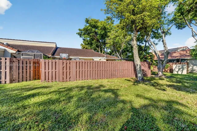 an aerial view of a house with a yard sitting space