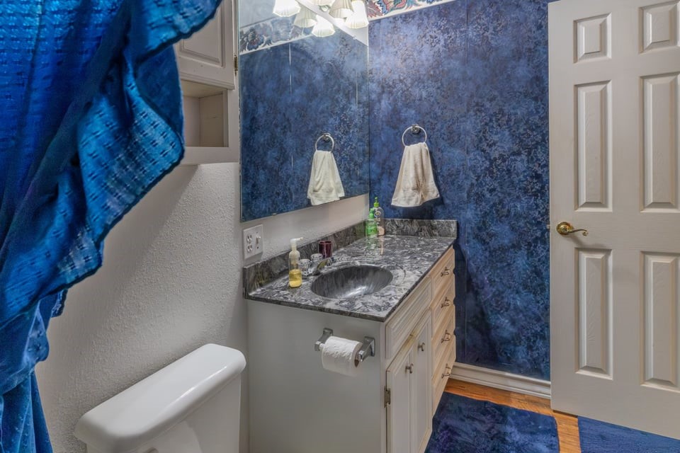 483 Riverside Drive Palacios, TX 77465 - Photo 21 of 41 a bathroom with a sink and toilet