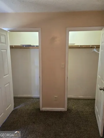 an empty room with wooden floor and a window