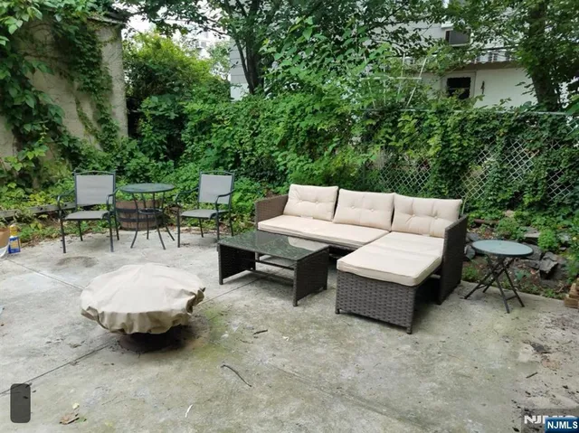 a view of patio with couches and a fire pit