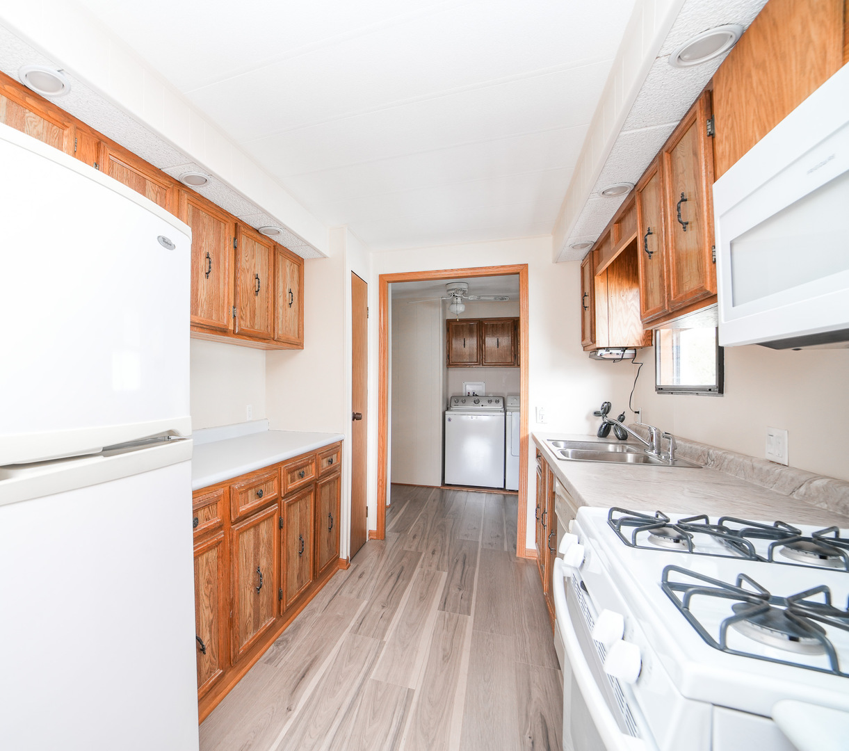 66 Maple Lane Manteno, IL 60950 - Photo 16 of 28 a kitchen with stainless steel appliances granite countertop a stove a sink dishwasher and a refrigerator with wooden floor