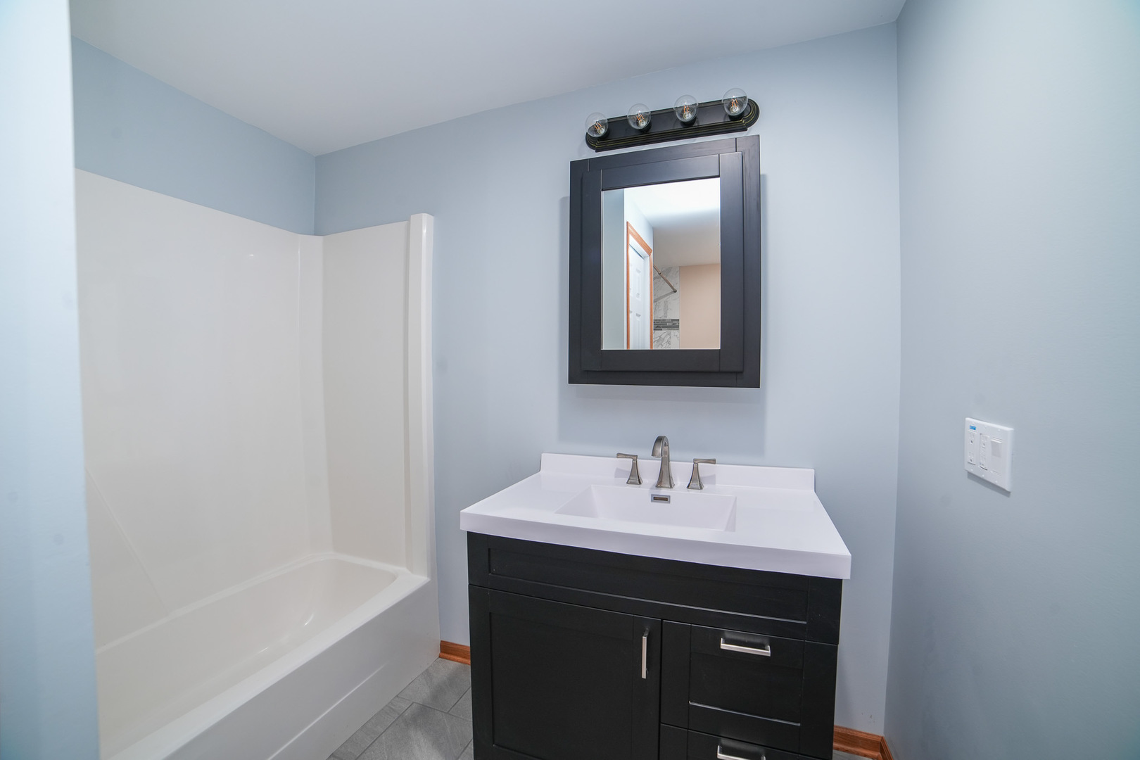 66 Maple Lane Manteno, IL 60950 - Photo 25 of 28 a bathroom with a sink a bathtub and a mirror