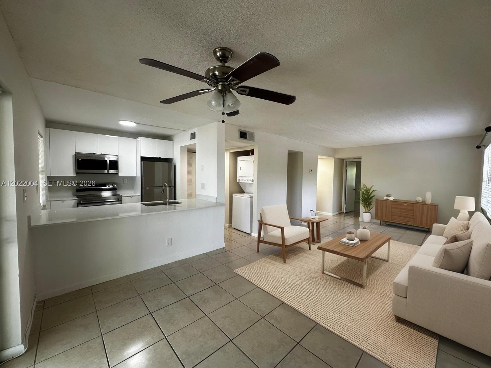 3400 Foxcroft Road, Unit 301 Miramar, FL 33025 - Photo 5 of 72 a living room with furniture and a flat screen tv