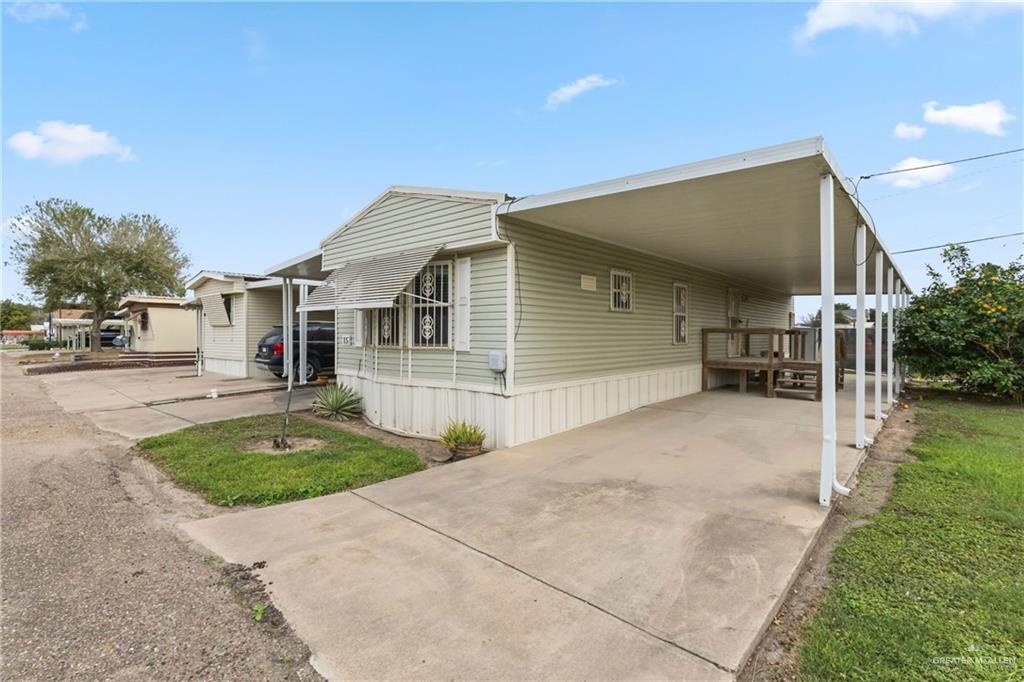 215 South Valley View Road, Unit 15&16 Donna, TX 78537 - Photo 13 of 13 a front view of a house with a yard and garage