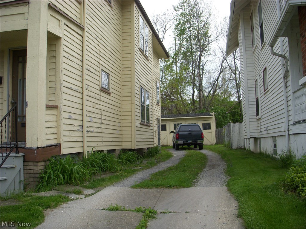 10419 Baltic Road Cleveland, OH 44102 - Photo 5 of 9 West side of property. Driveway is partially paved and the rest is gravel. Garage needs to be demolished.