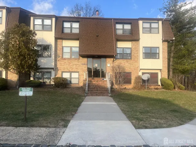 a front view of a residential apartment building with a yard