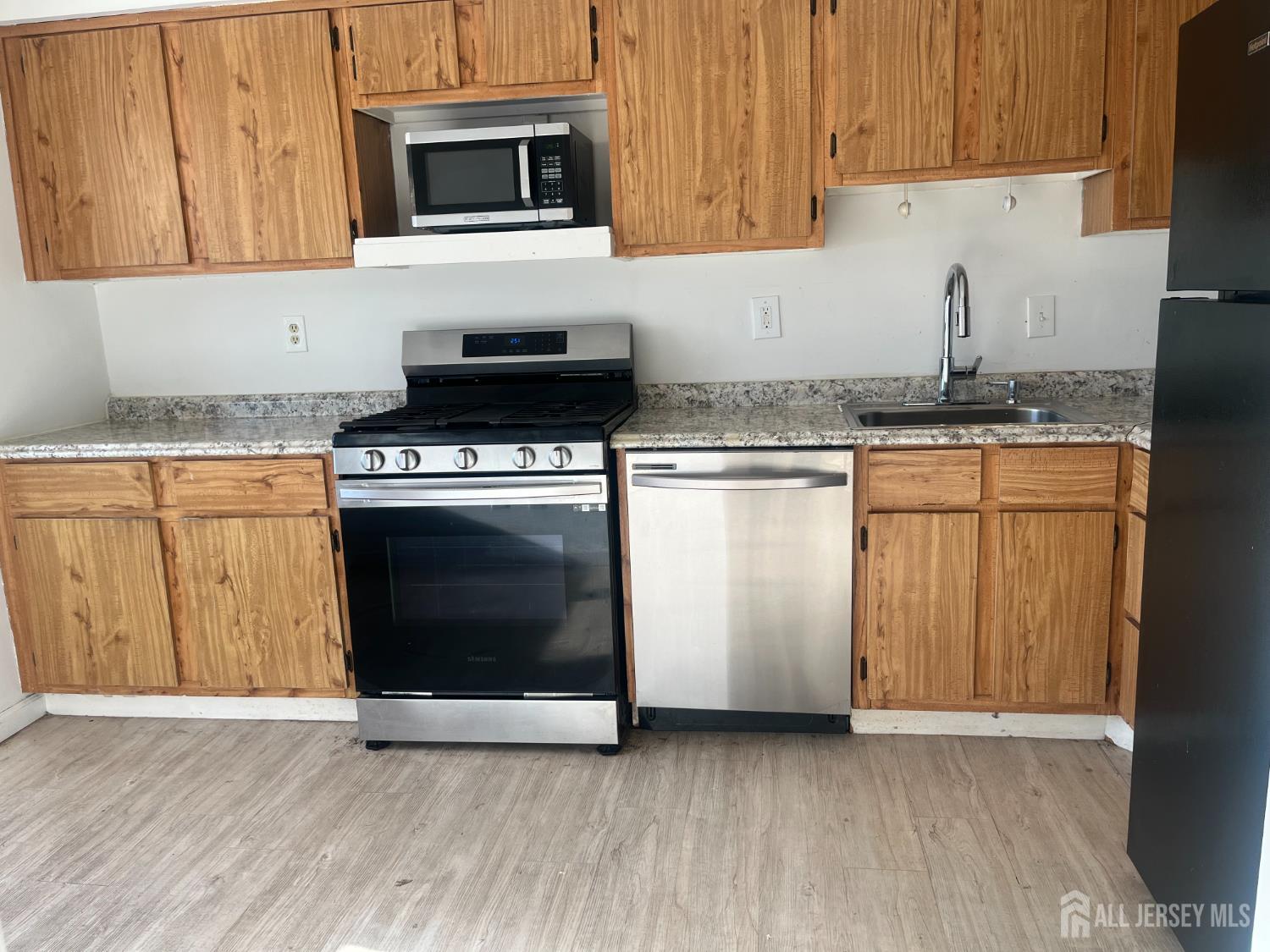 1947 Raspberry Court Edison, NJ 08817 - Photo 6 of 14 a kitchen with granite countertop a stove top oven and cabinets