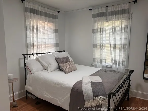 a bedroom with a bed and window