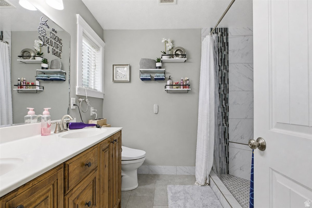 772 East 600 South Preston, ID 83263 - Photo 19 of 35 Bathroom featuring a wood-finish vanity with a white countertop and dual integrated sinks