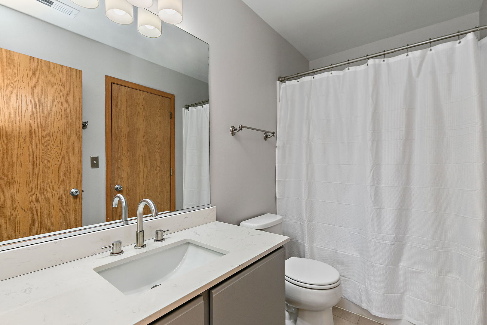 614 Littleton Trail Elgin, IL 60120 - Photo 21 of 30 a bathroom with a sink a toilet and shower curtain