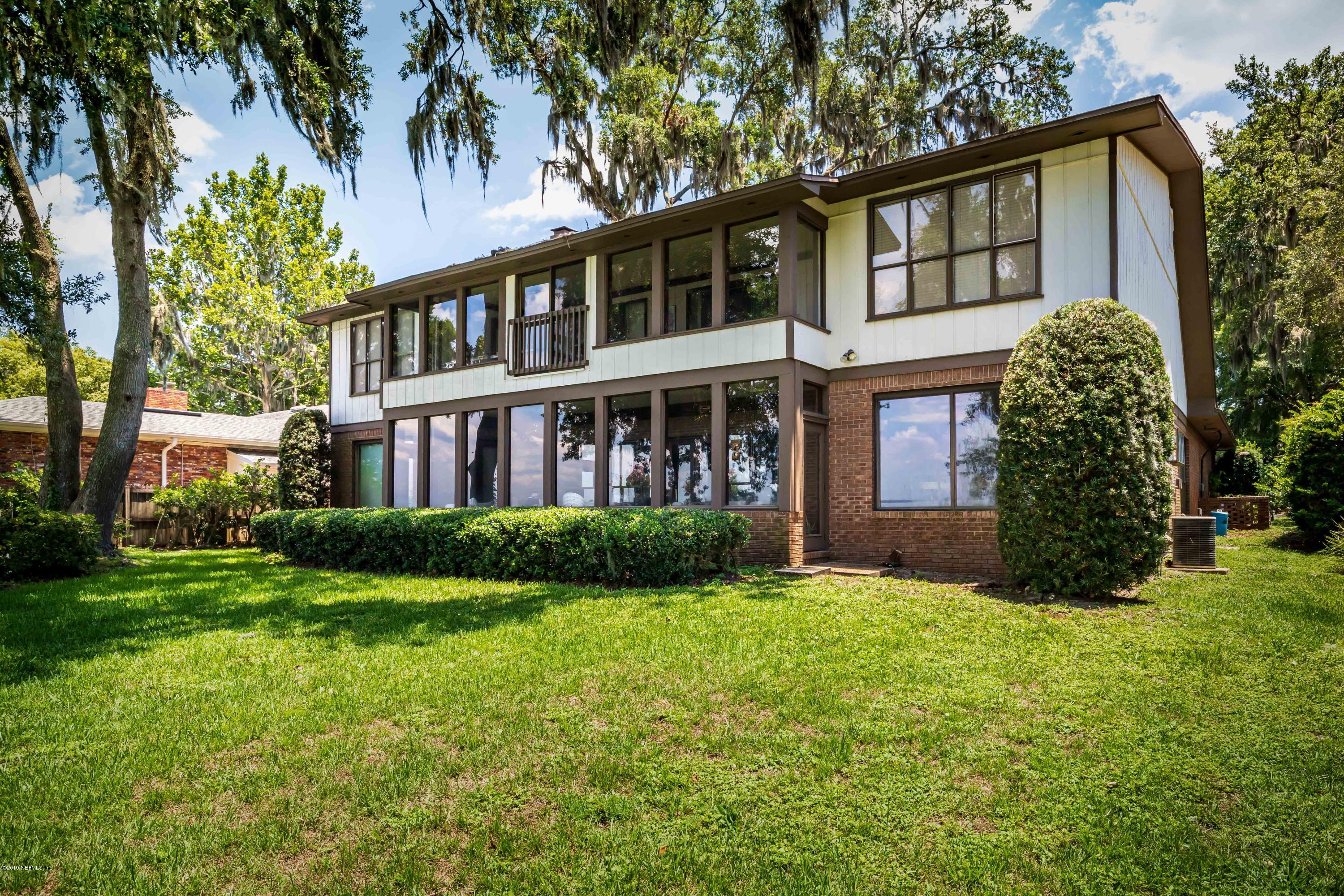 2911 Front Road Jacksonville, FL 32257 - Photo 12 of 71 a front view of a house with garden and trees