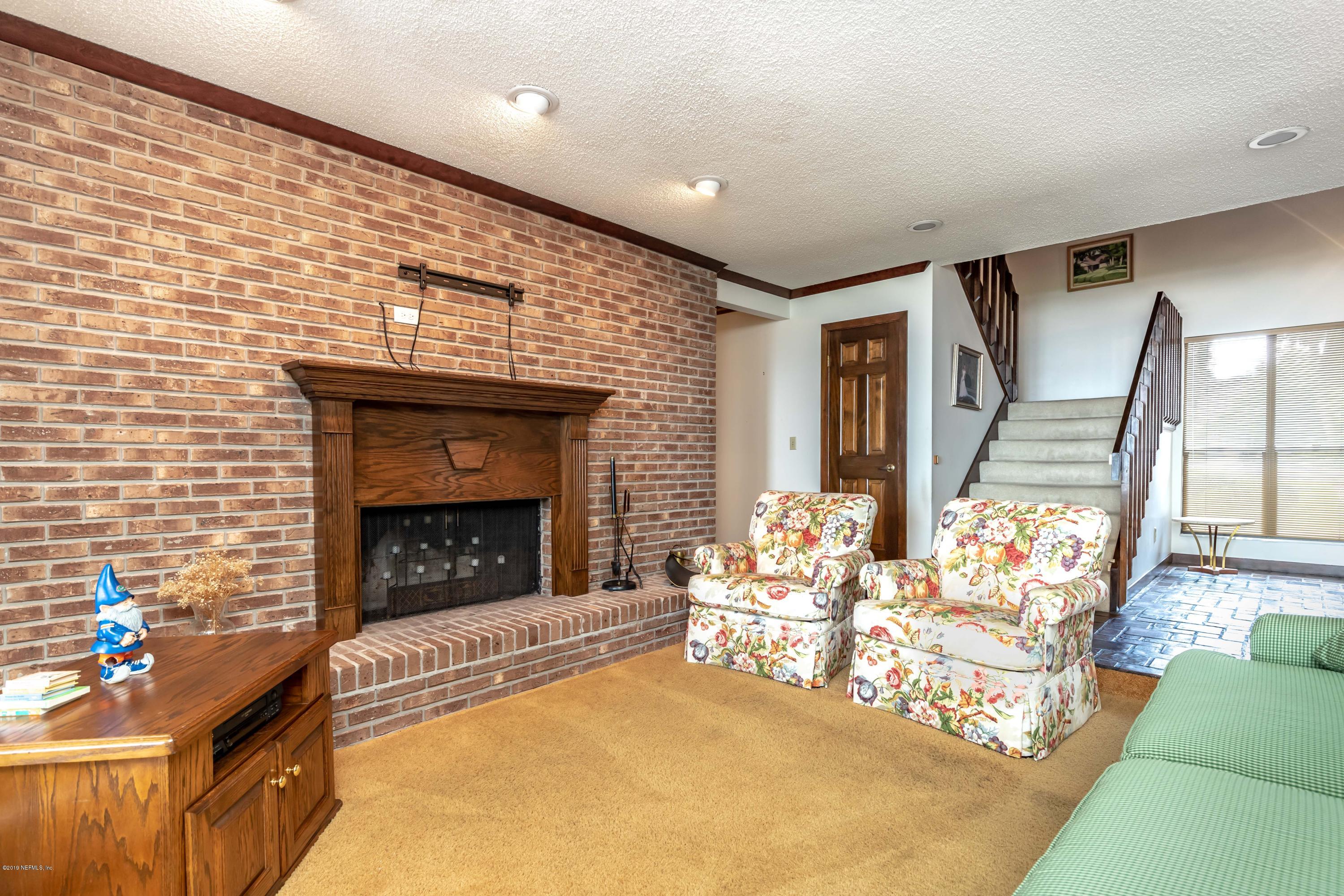 2911 Front Road Jacksonville, FL 32257 - Photo 22 of 71 a living room with furniture and a fireplace