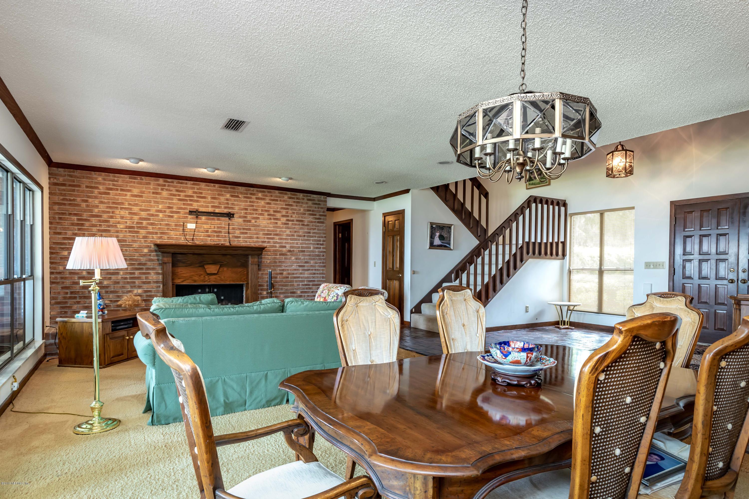 2911 Front Road Jacksonville, FL 32257 - Photo 26 of 71 a view of a dining room with furniture wooden floor and chandelier