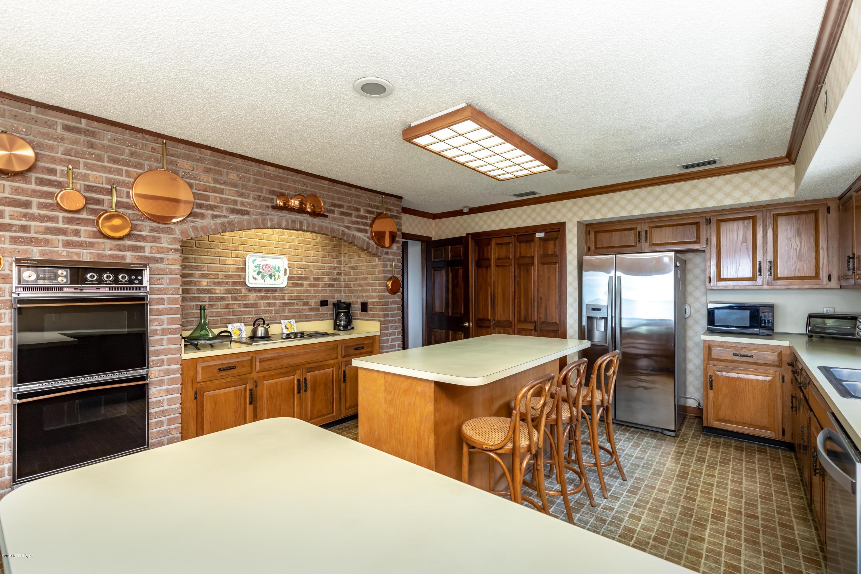 2911 Front Road Jacksonville, FL 32257 - Photo 32 of 71 a kitchen with stainless steel appliances granite countertop a stove top oven a sink a dining table and chairs