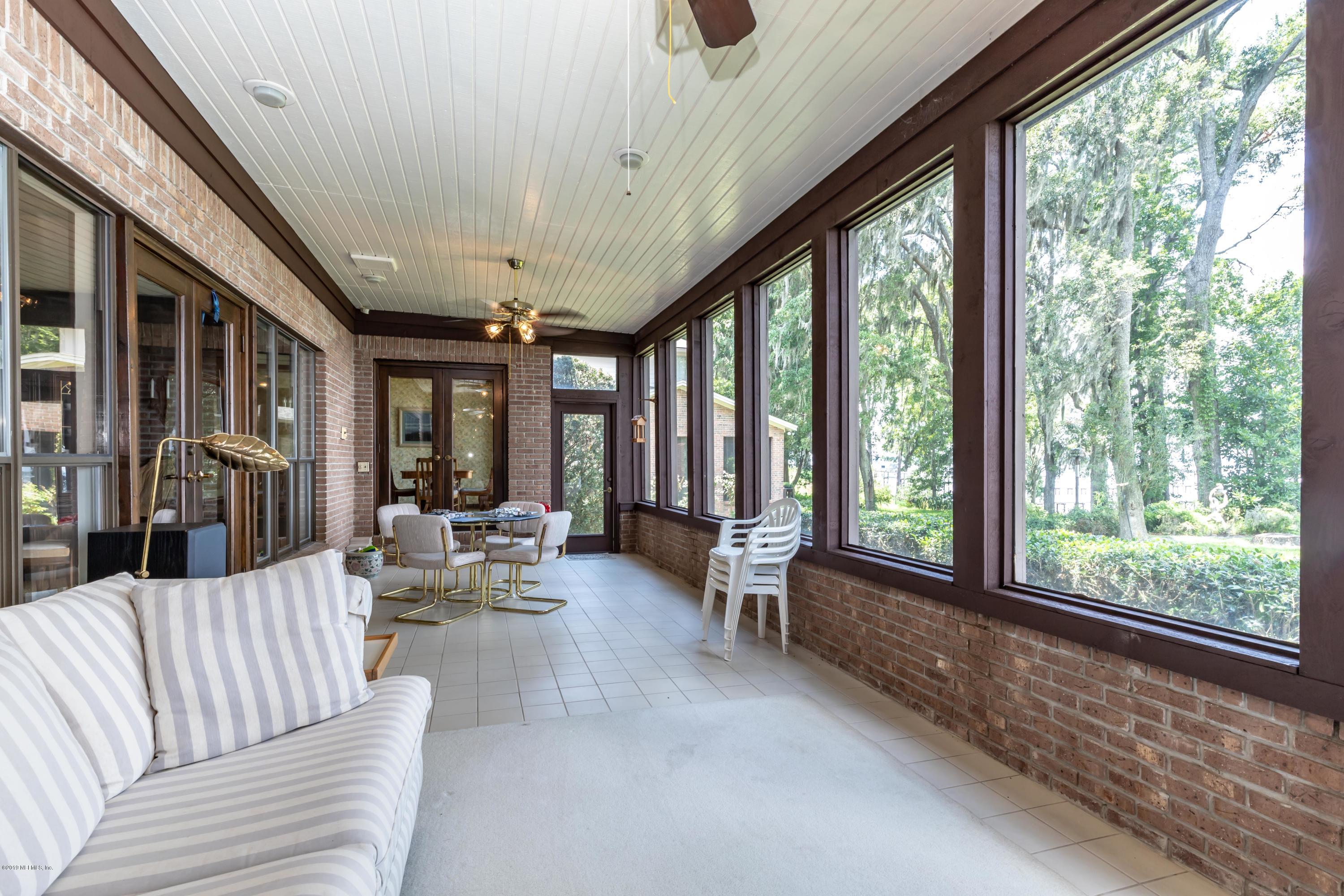 2911 Front Road Jacksonville, FL 32257 - Photo 38 of 71 a living room with furniture and floor to ceiling windows