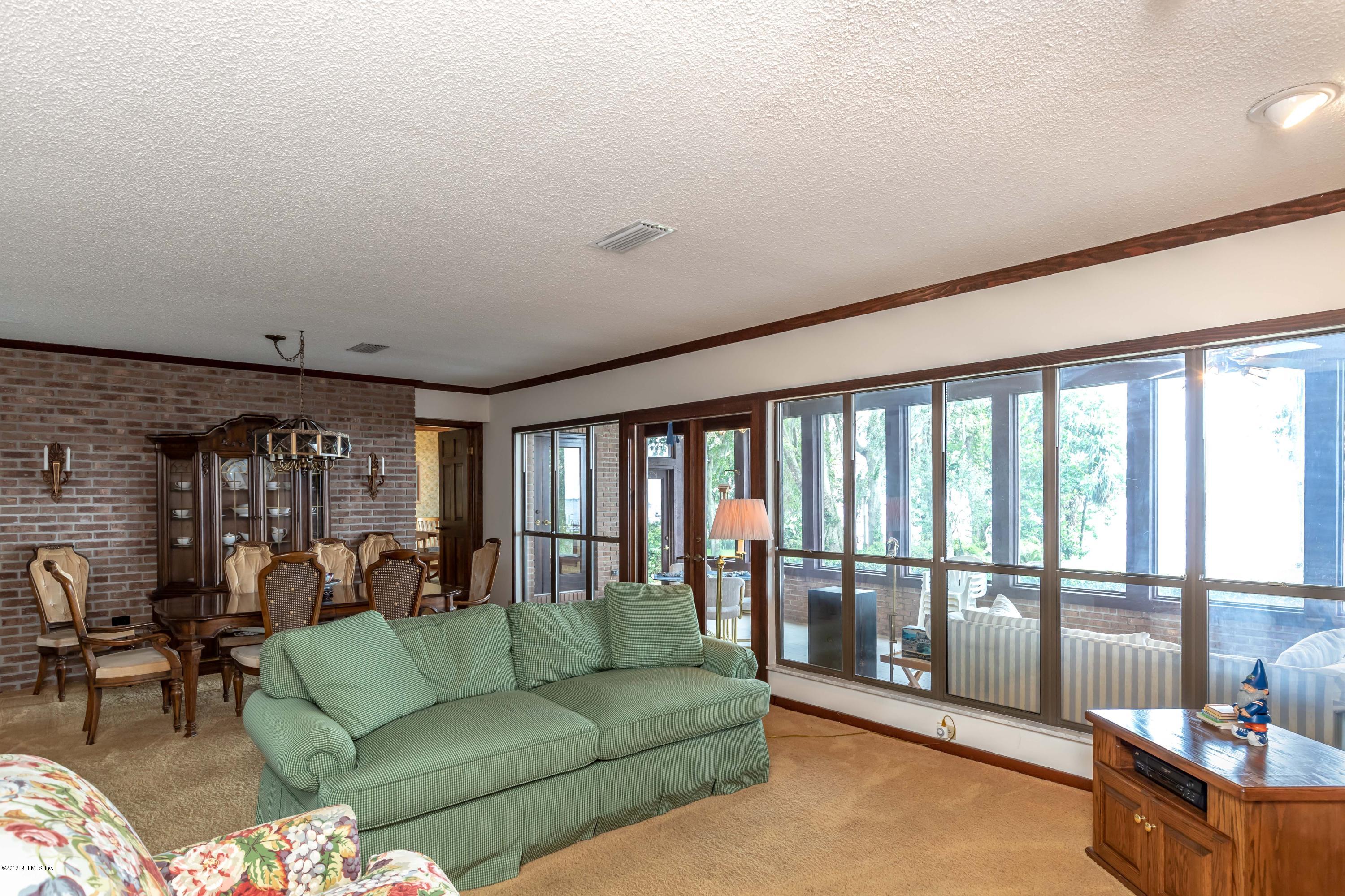 2911 Front Road Jacksonville, FL 32257 - Photo 4 of 71 a living room with furniture and a floor to ceiling window