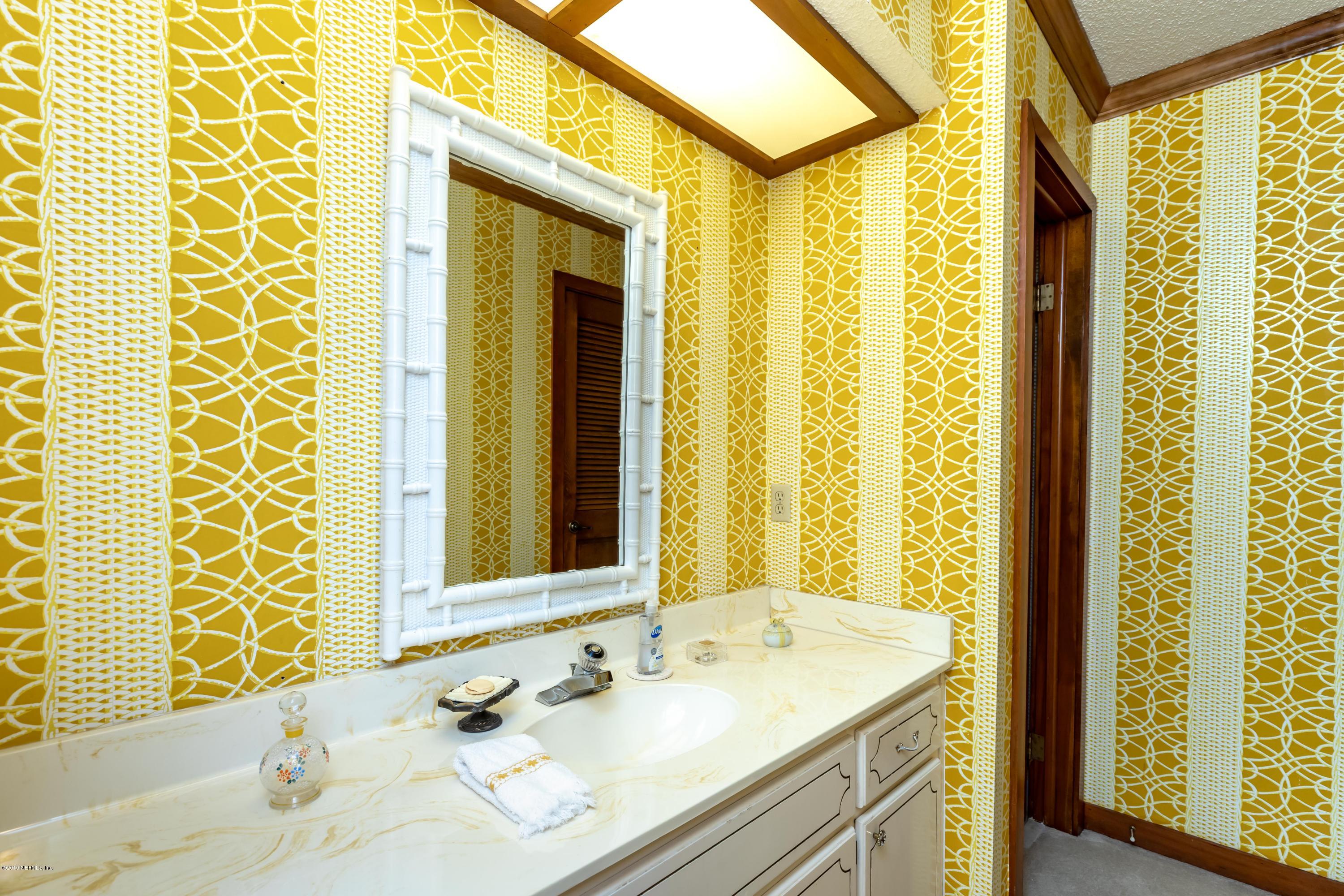 2911 Front Road Jacksonville, FL 32257 - Photo 50 of 71 a bathroom with a granite countertop sink and a mirror