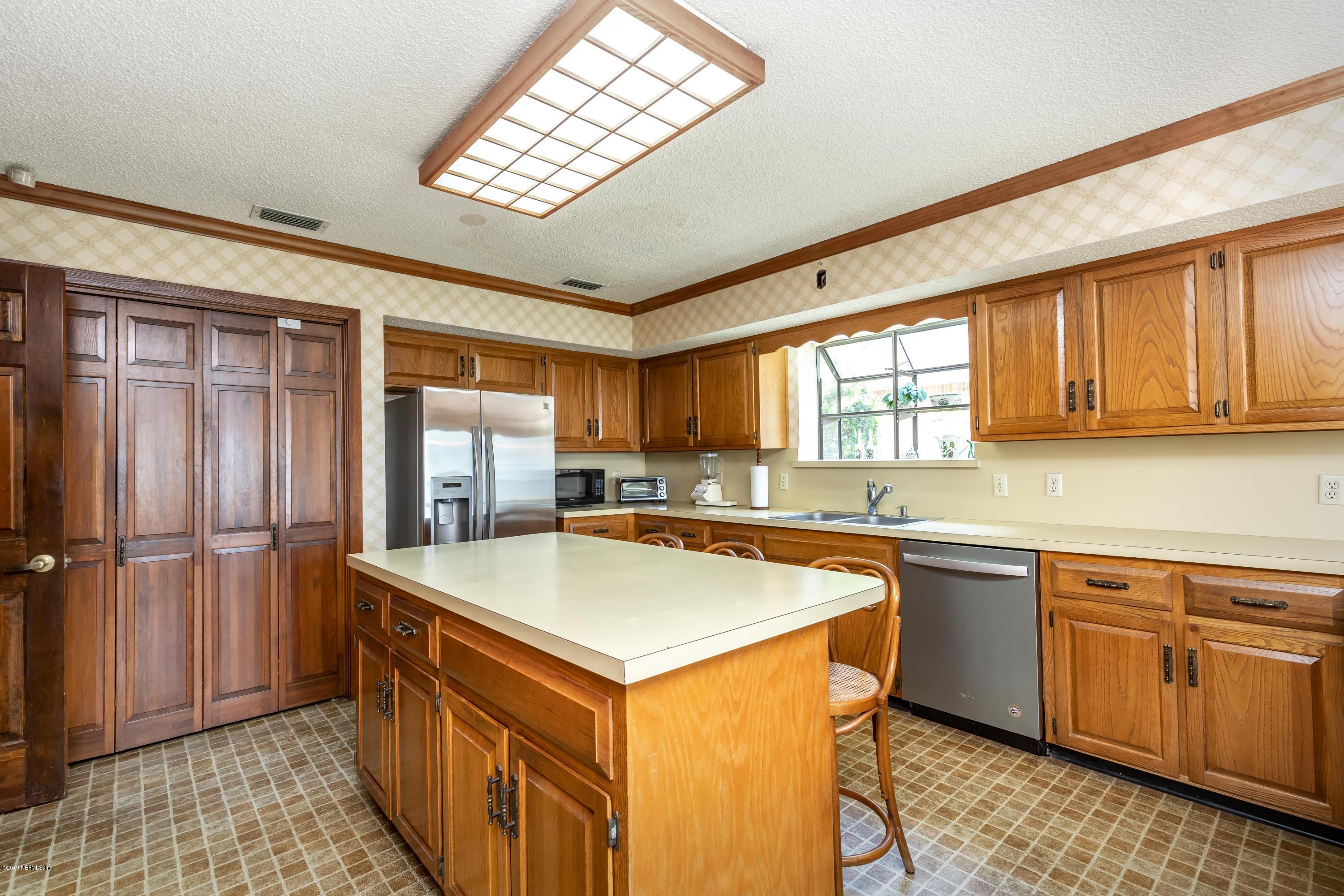 2911 Front Road Jacksonville, FL 32257 - Photo 5 of 71 a kitchen with stainless steel appliances granite countertop a refrigerator a sink dishwasher a stove and white countertops with wooden floor