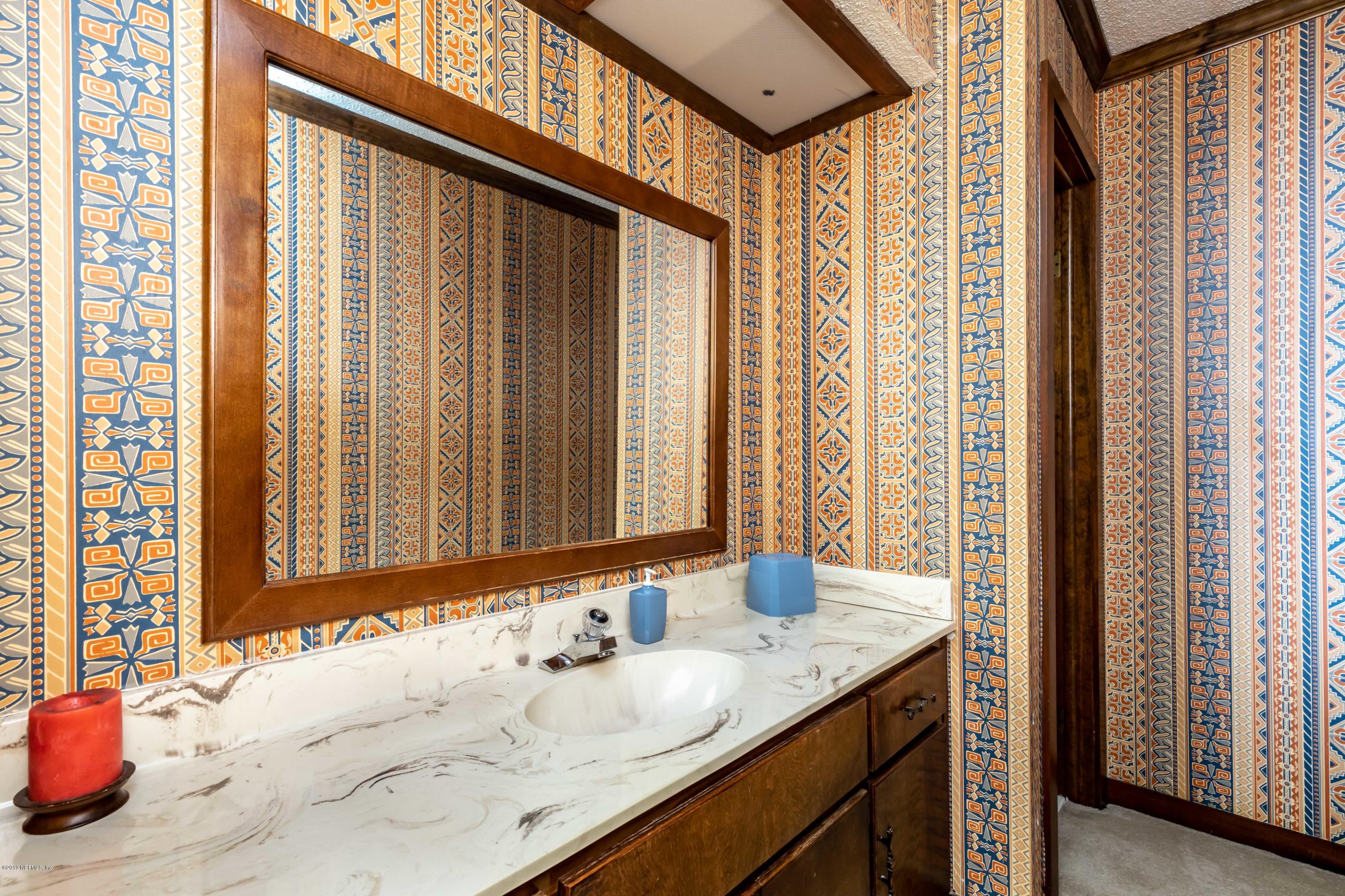 2911 Front Road Jacksonville, FL 32257 - Photo 56 of 71 a bathroom with a granite countertop sink and a large mirror