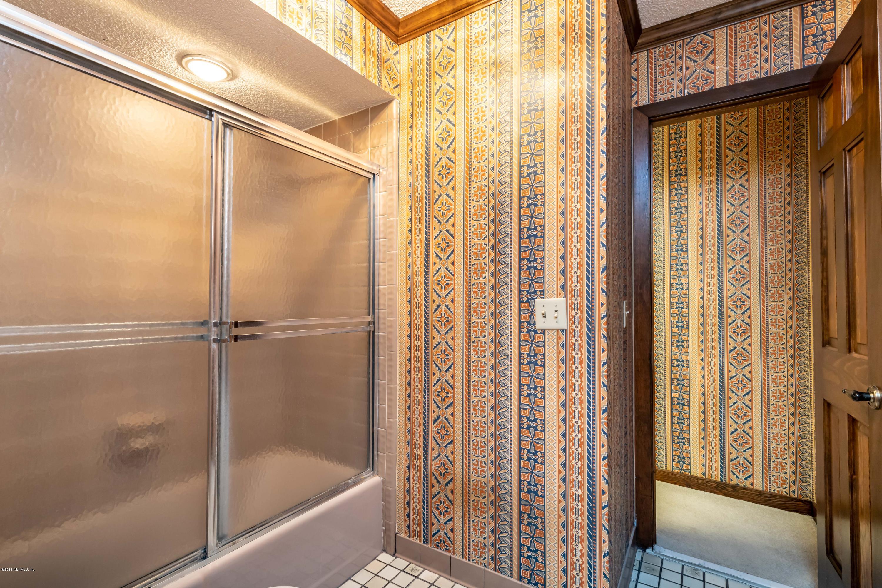 2911 Front Road Jacksonville, FL 32257 - Photo 57 of 71 a bathroom with a glass shower door