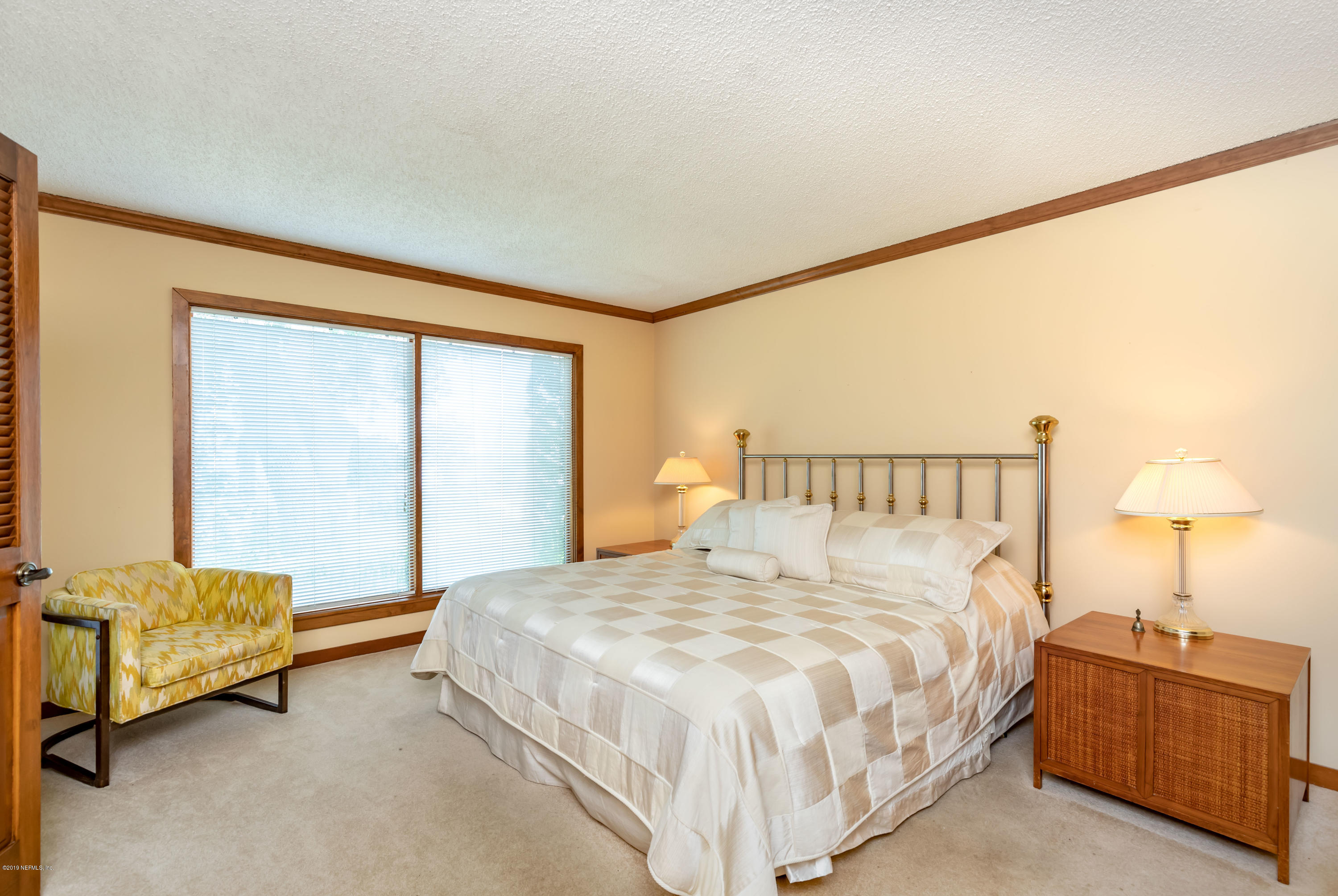 2911 Front Road Jacksonville, FL 32257 - Photo 6 of 71 a spacious bedroom with a bed and a lamp