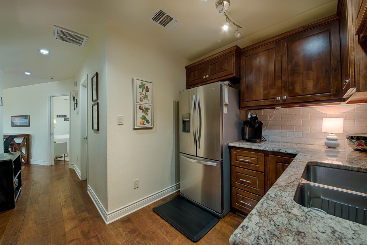1600 Legends Parkway Kingsland, TX 78639 - Photo 20 of 30 a kitchen with stainless steel appliances granite countertop a refrigerator and a sink