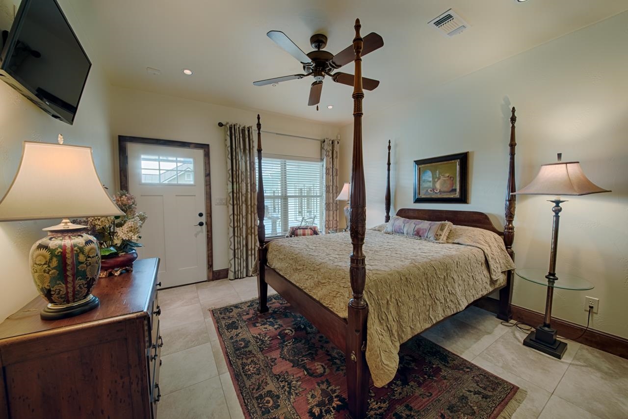 1600 Legends Parkway Kingsland, TX 78639 - Photo 24 of 30 a bedroom with a bed and a flat tv screen on dresser