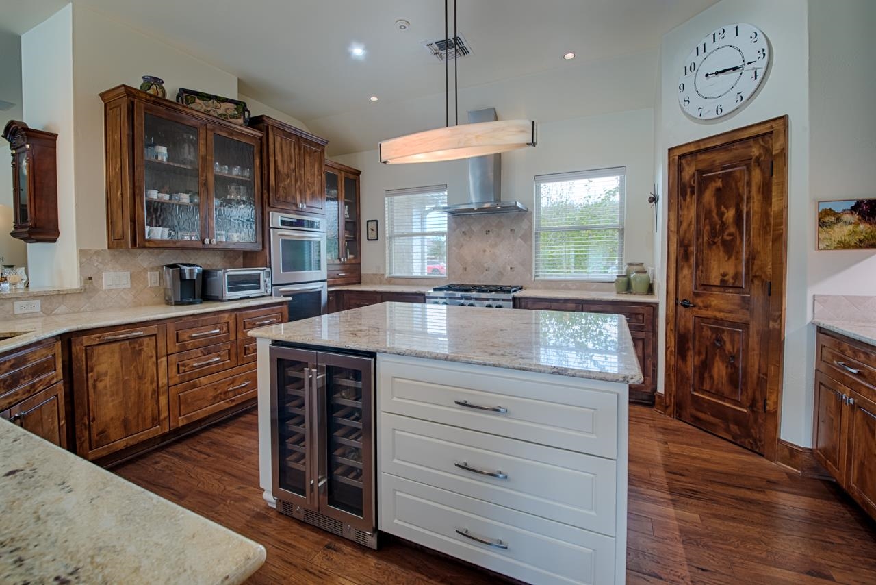 1600 Legends Parkway Kingsland, TX 78639 - Photo 5 of 30 a kitchen with stainless steel appliances granite countertop a stove refrigerator and cabinets