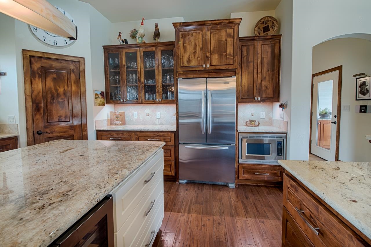 1600 Legends Parkway Kingsland, TX 78639 - Photo 6 of 30 a kitchen with kitchen island granite countertop wooden cabinets and a refrigerator