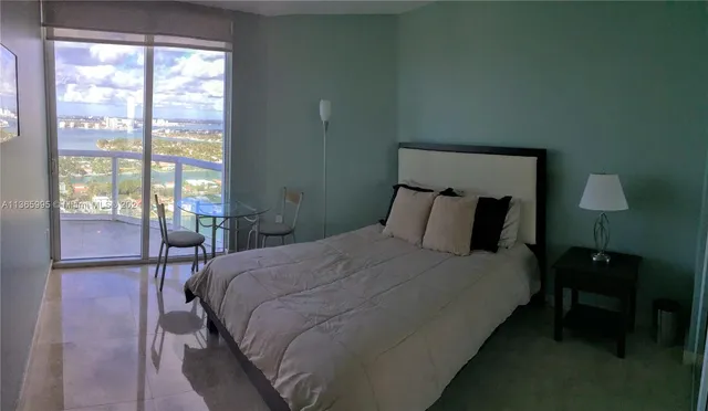 a bedroom with a bed and a lamp on table