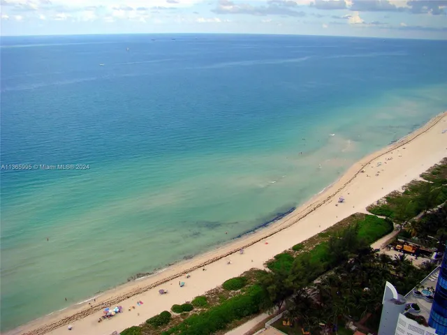 a view of a field with an ocean view