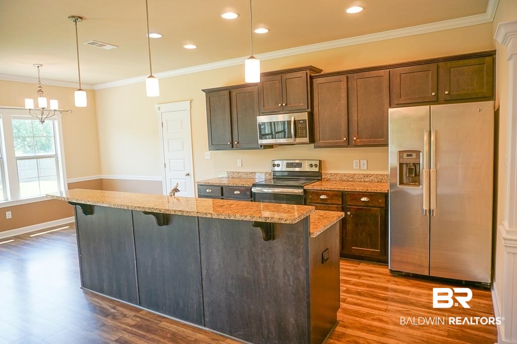 593 Begeman Road Mobile, AL 36608 - Photo 6 of 23 Kitchen with dark hardwood / wood-style floors, pendant lighting, a center island with sink, and stainless steel appliances