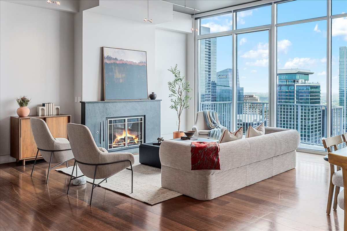 360 Nueces Street, Unit 4305 Austin, TX 78701 - Photo 1 of 1 a living room with furniture large window and a fireplace