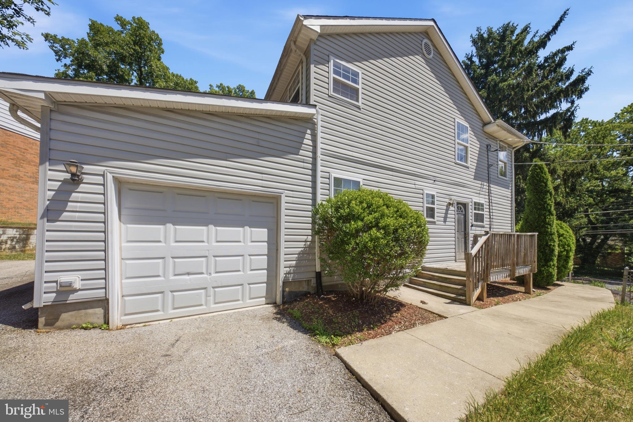 7611 Temple Hill Road Temple Hills, MD 20748 - Photo 3 of 25 a front view of a house with a yard