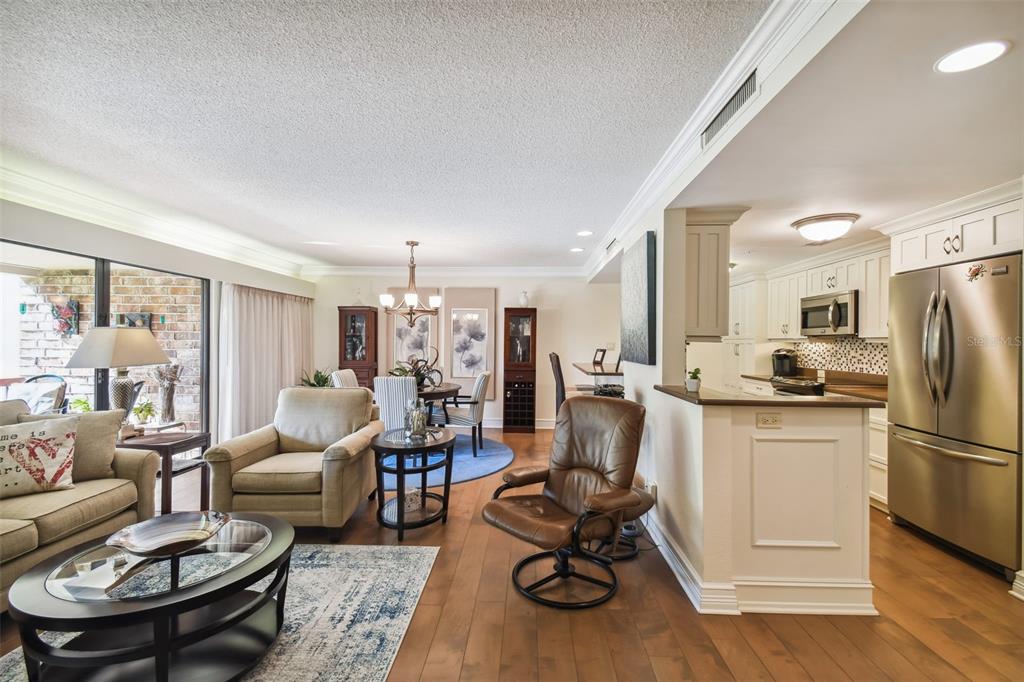 36750 Highway 19, Unit 23213 Palm Harbor, FL 34684 - Photo 14 of 73 a living room with furniture kitchen view and a refrigerator