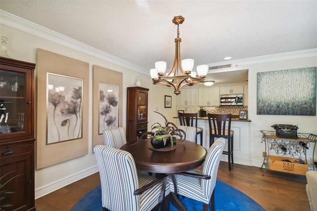 36750 Highway 19, Unit 23213 Palm Harbor, FL 34684 - Photo 16 of 73 a view of a dining room with furniture wooden floor and chandelier