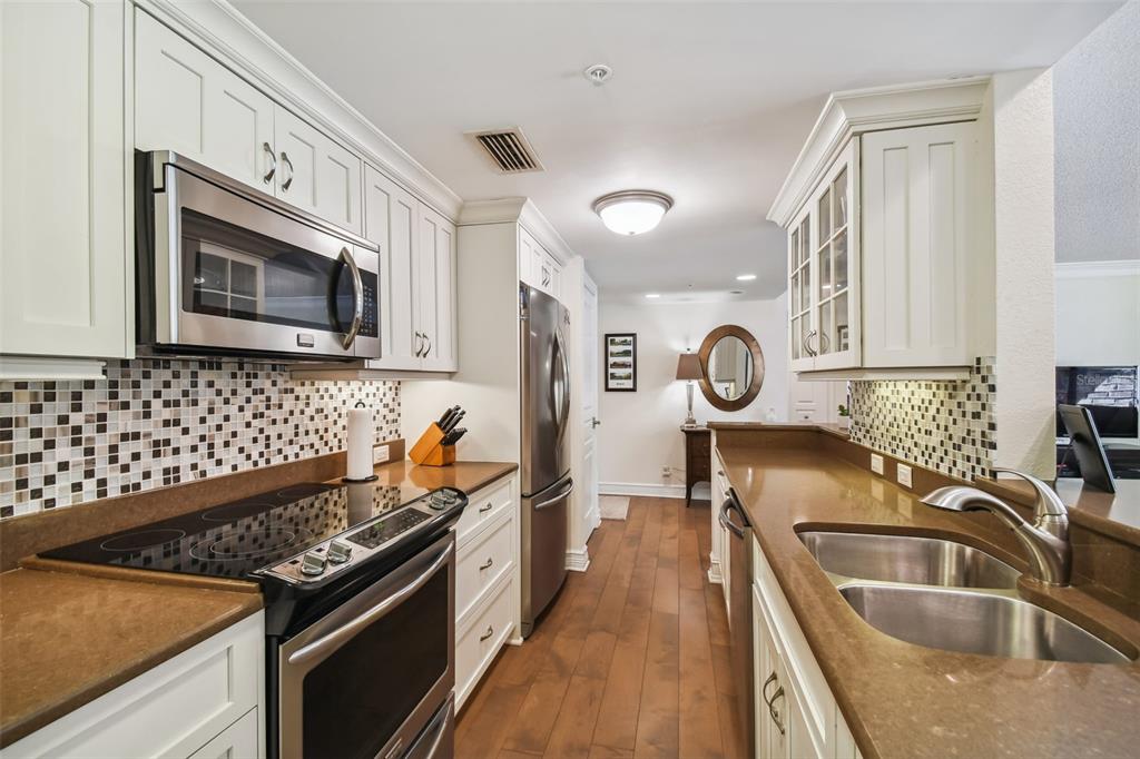 36750 Highway 19, Unit 23213 Palm Harbor, FL 34684 - Photo 7 of 73 a kitchen with granite countertop a sink stove and cabinets