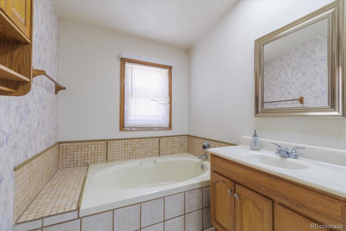 2283 Haskell Way Watkins, CO 80137 - Photo 13 of 36 a bathroom with a sink and a bathtub