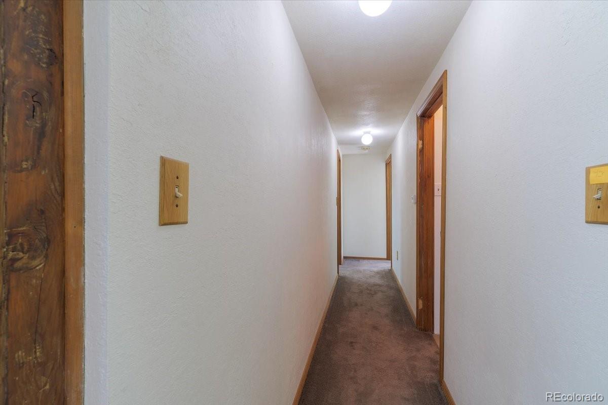 2283 Haskell Way Watkins, CO 80137 - Photo 19 of 36 a view of a hallway with wooden floor