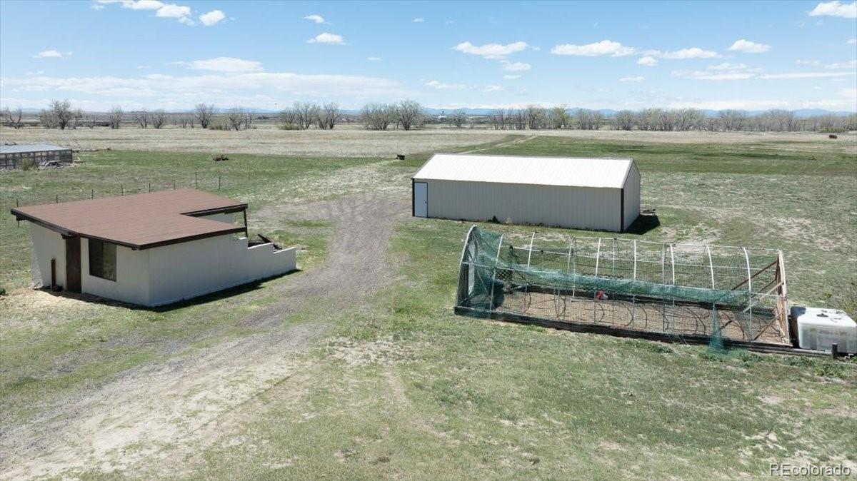 2283 Haskell Way Watkins, CO 80137 - Photo 23 of 36 an aerial view of a house with garden space and lake view